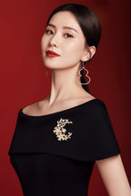 A lady wearing an elegant laurel goddess brooch, adorned with natural pearls and shell flowers.