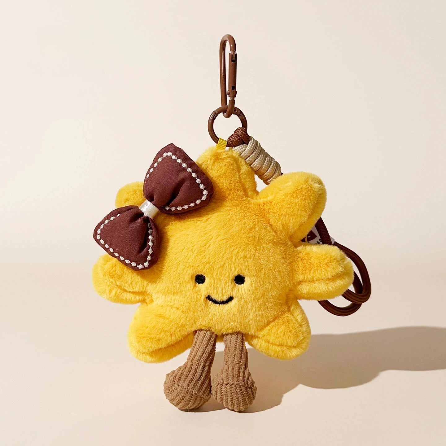 Sunflower Smile Plush Bag Charm - product image 1 showing the sunflower character bag charm